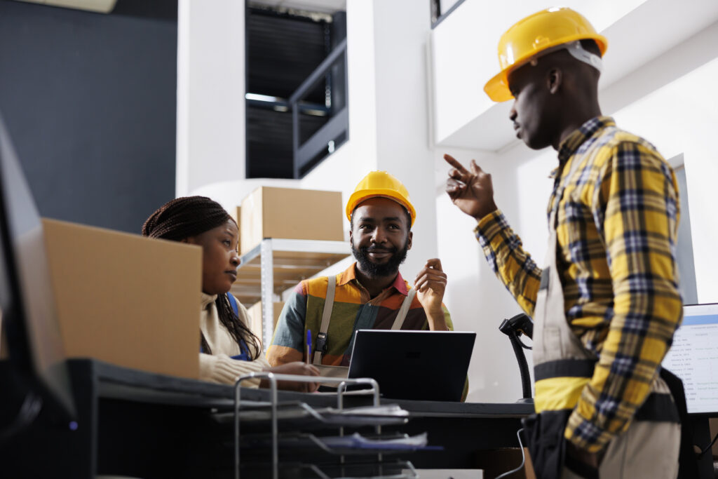 Logistics managers team dicussing goods distribution at warehouse reception